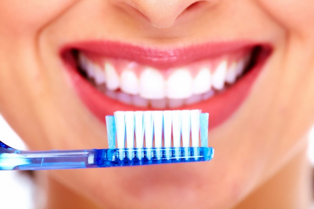 woman brushing her teeth